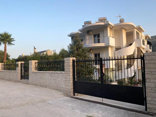 a black fence in front of a house at Bafas Apartments in Plataria