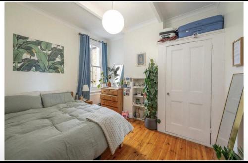 a bedroom with a bed and a white door at Luxury Flat in the heart of South London in London