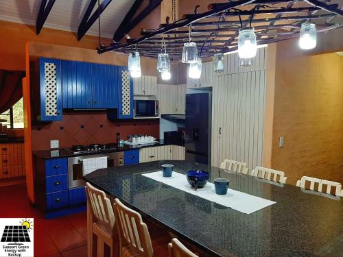 a kitchen with blue cabinets and a counter top at SnL 12 Dwergarend in Malelane