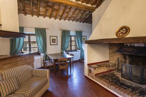 a living room with a couch and a fireplace at Relais Riserva di Fizzano in Castellina in Chianti