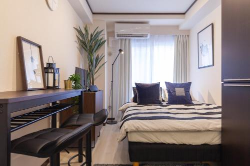 a bedroom with a bed and a table and a piano at Chez Moi royale in Tokyo