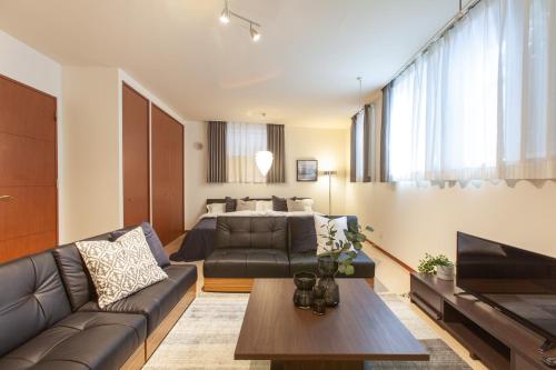 a living room with a couch and a bed at Granado Roppongi in Tokyo
