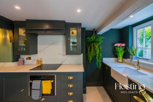 a kitchen with a sink and a counter top at The Palm Retreat Marlow in Marlow
