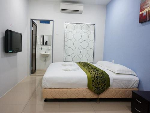 Asia Green Hotel tesisinde bir odada yatak veya yataklar