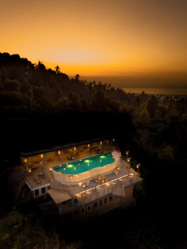 an overhead view of a swimming pool at night at Maha Hills Resort by Mahaprana Experience in Lovina