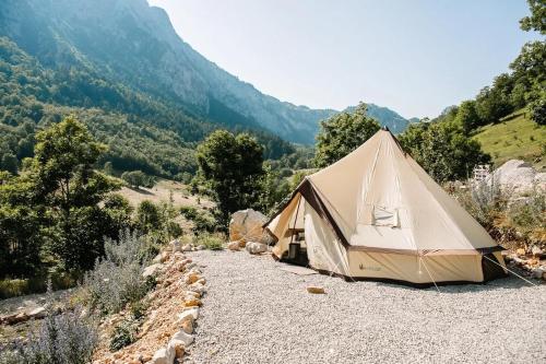 a tan tent sitting on top of a mountain at Ursa Camp in Gornje Lipovo