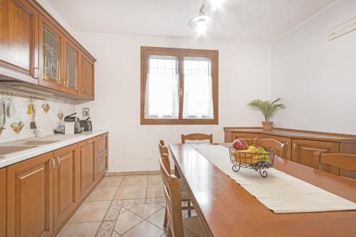 a kitchen with a table with a basket of fruit on it at Villa Porpora Luxury Design in Modena