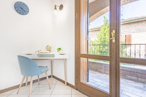 a room with a desk and a chair next to a window at Villa Porpora Luxury Design in Modena