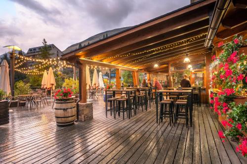 a restaurant with tables and chairs on a wooden deck at Tuc Blanc in Baqueira-Beret
