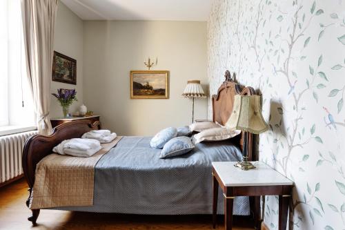 a bedroom with a bed with pillows on it at Burbiskio dvaras in Anykščiai