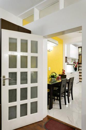 a door leading into a dining room with a table at Moydom Nice & Cosy Private 1 BHK Apartment OPP NFC market in New Delhi