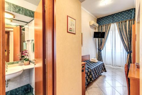 a bathroom with a sink and a mirror at Hotel Orlanda in Rome