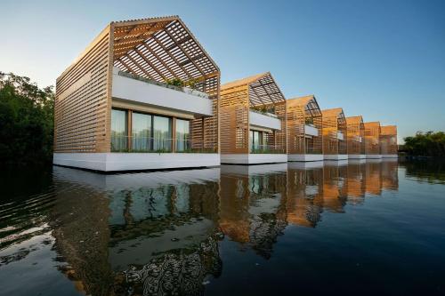 a row of buildings on a body of water at Banyan Tree Mayakoba in Playa del Carmen