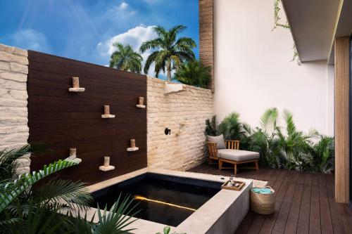 a swimming pool in the middle of a patio at Banyan Tree Mayakoba in Playa del Carmen