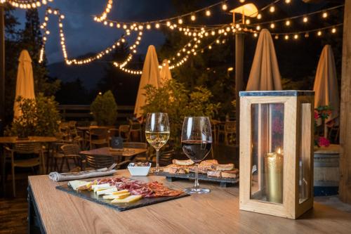 a table with a plate of food and wine glasses at Tuc Blanc in Baqueira-Beret