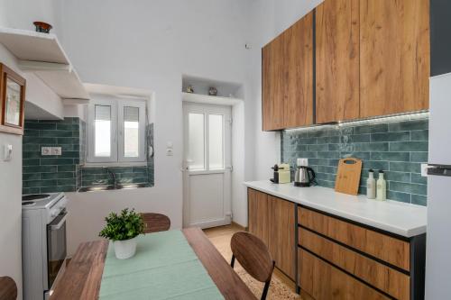 a kitchen with a table and a counter top at Blue Sky in Plaka in Plaka Milou