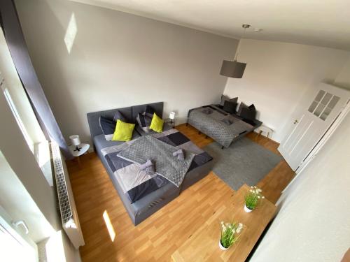 an overhead view of a living room with a couch at City Apartments Erfurt in Erfurt