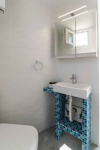 a bathroom with a sink and a toilet at Blue Sky in Plaka in Plaka Milou