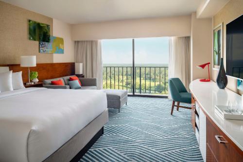 a hotel room with a bed and a large window at Hyatt Regency Grand Cypress Resort in Orlando