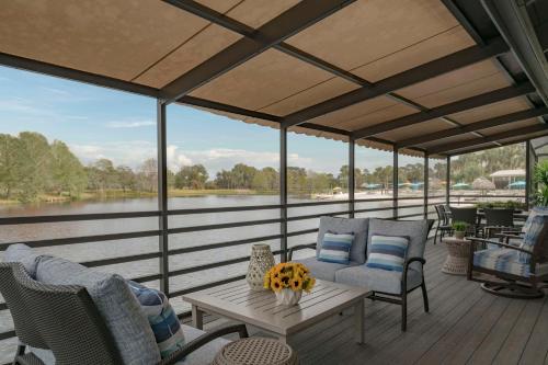 a screened in porch with chairs and a table at Hyatt Regency Grand Cypress Resort in Orlando