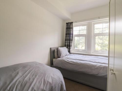 a bedroom with a bed and a window at 3 Glendowne Terrace in Harrogate