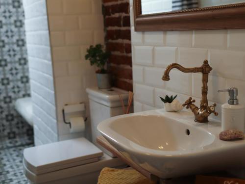 a bathroom with a sink and a toilet at Good Stay Sofia Apartments in Sofia