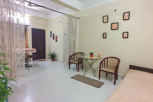 a living room with a table and chairs at Mimo's in Guwahati