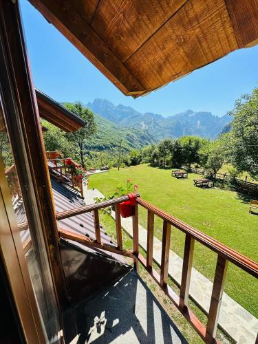 a balcony with a view of a field and mountains at Royal Land in Theth