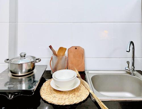 un bancone della cucina con lavandino e ciotola su un piatto di Anna House ad Ho Chi Minh