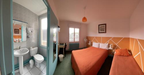 a small bathroom with a bed and a sink at Relais Henri IV in La Flèche