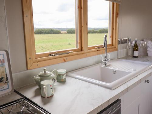 a kitchen counter with a sink and a window at Shepherds Hut in Scunthorpe