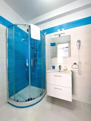 a bathroom with a glass shower and a sink at Villa Milena Apartments & Rooms in Agropoli