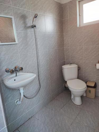 a bathroom with a toilet and a sink and a shower at Fa Mol in Sunny Beach