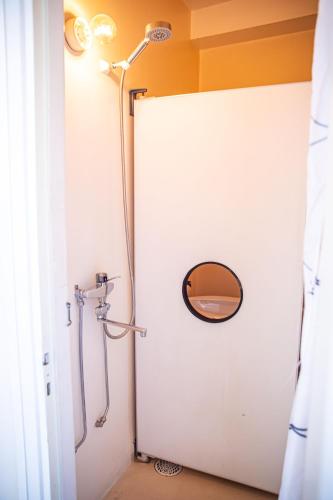 a bathroom with a white door and a mirror at Saga Hotell in Borlänge