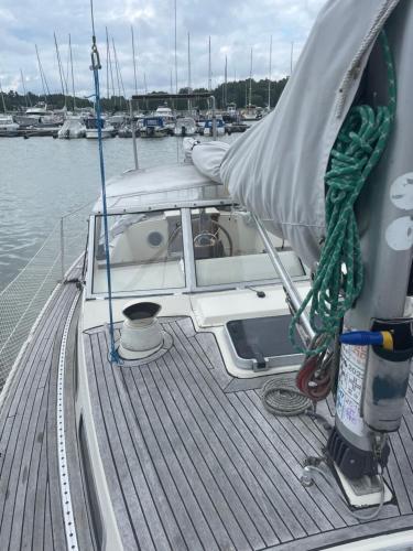 a boat is tied up on a dock in the water at Lovely Sailingboat room near center in Helsinki