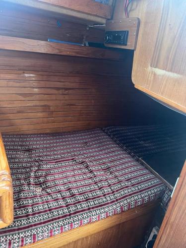 a small room with a bed with a pattern on it at Lovely Sailingboat room near center in Helsinki