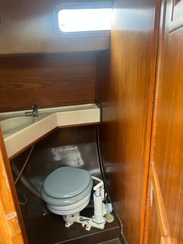 a small bathroom with a toilet in a train at Lovely Sailingboat room near center in Helsinki