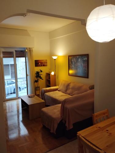 a living room with a bed and a couch at Vasia's cosy apartment in Athens, "Pedion tou Areos", close to center in Athens