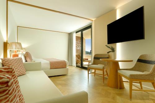 a hotel room with a bed and a tv at TRS Ibiza Hotel - Adults Only in San Antonio