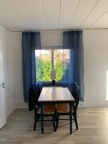 a table and two chairs in a room with a window at 4 Bed Apartment outdoor space in Karlskrona in Karlskrona