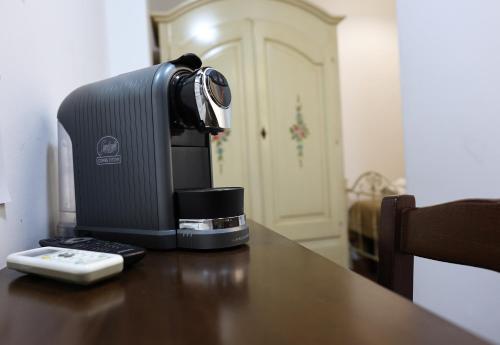 a coffee maker sitting on a table with a remote control at Rabatè in Agrigento