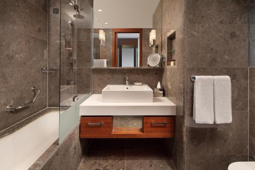 a bathroom with a sink and a glass shower at Sheraton Istanbul Atakoy Hotel in Istanbul