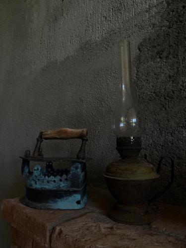a vase and a lamp sitting next to a wall at ,,Anna's" Guesthouse in K'vemo Alvani