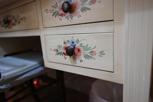 a cabinet with flowers painted on the fronts of it at Rabatè in Agrigento
