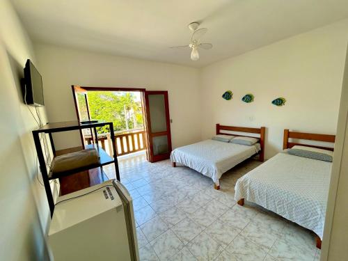 Una cama o camas en una habitación de Pousada Recanto da Traineira