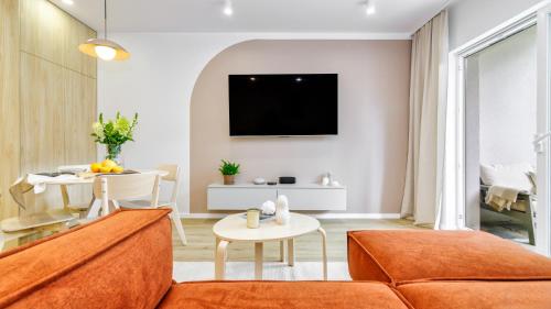 a living room with a couch and a table at InTheMiddle in Ostróda
