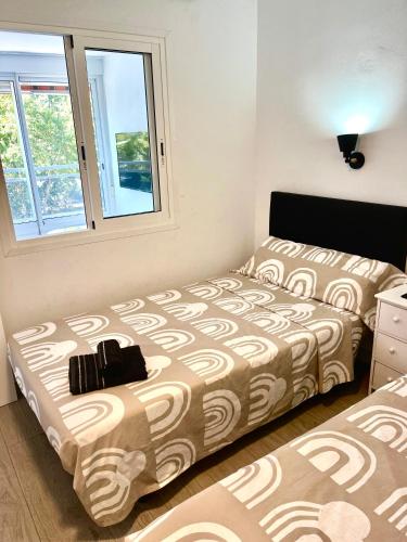a bedroom with two beds and a window at Apartment Ducado 41 Benidorm Playa levante 4 P in Benidorm