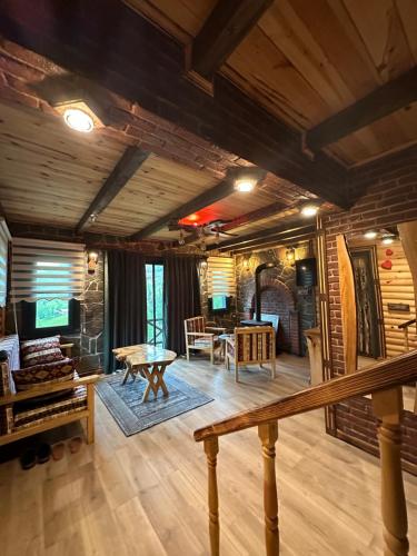 a large living room with wooden walls and wooden floors at DELLA SUİT BUNGALOW in Çamlıhemşin