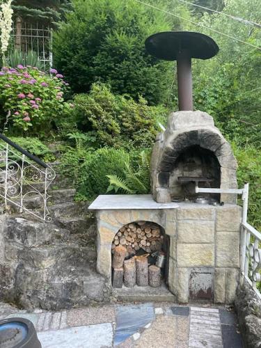 a stone outdoor oven with a fountain on top at Villa u Rytíře in Hřensko