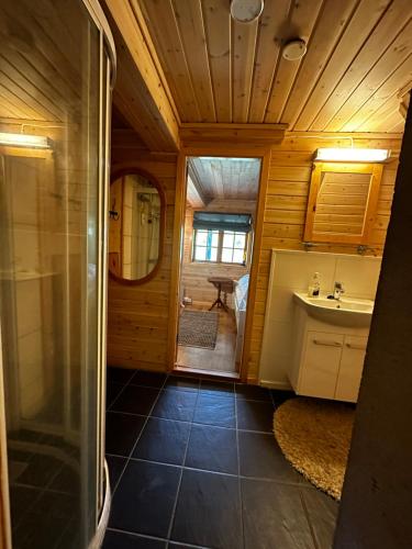 a bathroom with a shower and a sink at Large and cosy mountain cabin in Sykkylven